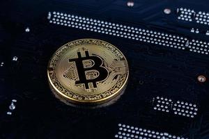 bitcoin physical shiner on black electronic board with selective focus and blur photo