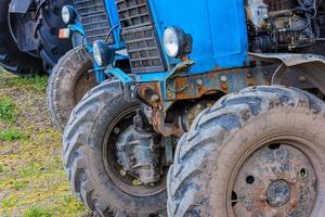 blue belarussian tractors, wheels and opened diesel engine compartment view photo