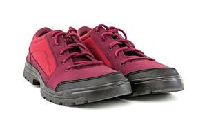 a pair of simple cheap crimson red hiking shoes isolated on white background - perspective close-up view photo