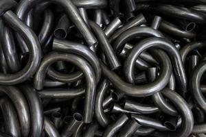 abstract black industrial full frame background of bended steel pipes photo