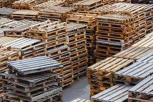 full frame background of used wooden pallet stacks - perspective view from above photo