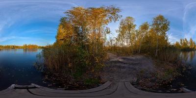 Full spherical 360 by 180 degrees panorama of evening autumnal lake with birch forest on its shores photo