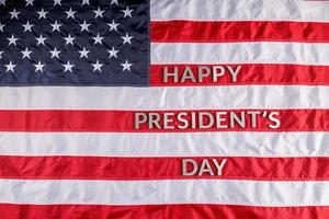 words happy presitdents day laid with real letters on US flag surface photo