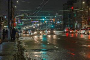 Tula, Russia December 20, 2020 Night automobile traffic on wide city street - close-up telephoto shot photo