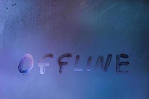 word offline handwrittern on foggy glass with cold neon blue back light photo