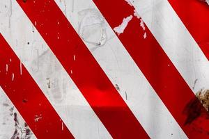 red and white diagonal stipes on flat steel sheet - caution road sign photo