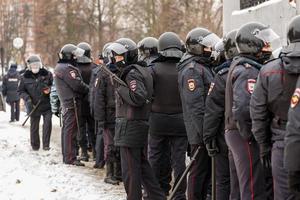 TULA, RUSSIA  JANUARY 23, 2021 Public meeting in support of Navalny, police officers in black helmets wait for the command to arrest the protesters. photo