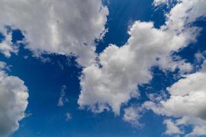 Regular spring clouds on blue sky at daylight in continental europe. Upward shot with wide angle lens without filter. photo