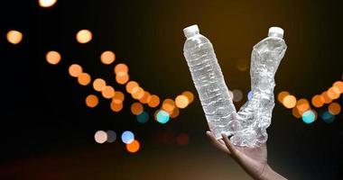 Giving plastic bottle to make recyclying, reusing and reducing objects to lower garbage and to keep our environment clean and clear to everyone concept, soft and selective focus. photo