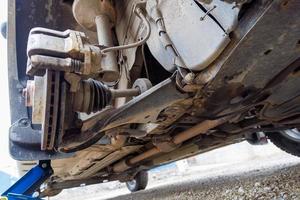 the hub of the front wheel of a jacked car during a tire change photo