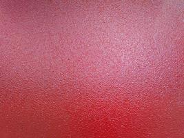 fondo de recubrimiento de pintura en polvo de shagreen rojo sobre una superficie de chapa de acero plana foto