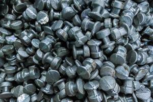 An abstract industrial full frame background of forged and sanded steel billets. Close-up with selective focus and blur. photo