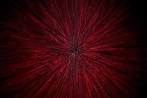 natural lens zoom explosion radial blurred red particles on black background with selective focus photo