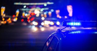 night police car lights in city - close-up with selective focus and bokeh photo