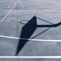 basketball hoop silhouette on the court, sports equipment photo