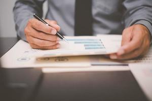Businessman validates and manages business documents and agreements. , signing a business contract approval of contract documents confirmation or warranty certificate,employment idea, project review photo