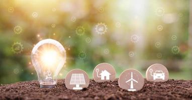 protecting the environment alternative energy Sustainable renewable energy sources Green energy innovation and environmentally friendly energy technology,Light bulbs and wooden blocks are in the soil. photo