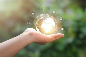 environmental conservation concept, protecting and preserving resources, planting trees to reduce global warming, using renewable energy, preserving natural forests,icon in hand, nature background photo