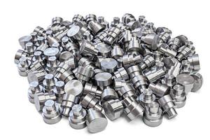 batch of shiny steel cnc turned parts isolated on white background photo