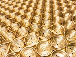 an abstract perspective industrial close-up background of shiny brass metal threaded hexagonal fitting parts photo