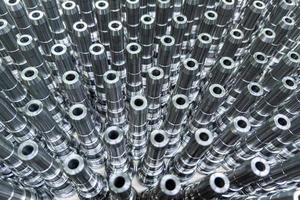 Shiny long steel parts full frame background, clean steel rods after fine cnc turning. photo