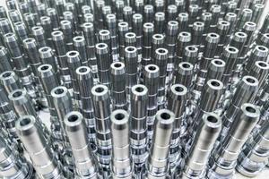 Shiny long steel parts full frame background, clean steel rods after cnc turning photo