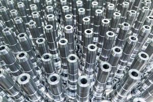 Shiny long steel parts full frame background, clean steel rods after fine cnc turning. photo