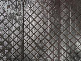 old cast iron factory floor tiles with checkered skid-proof pattern photo