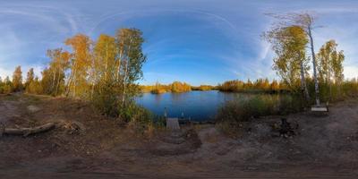 Full spherical 360 by 180 degrees panorama of evening autumnal lake with birch forest on its shores photo