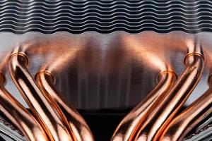 Modern tower heat radiator with six copper heatpipes close-up macro background. photo