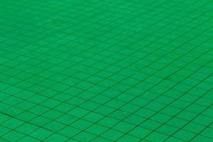 green plastic tiles on the floor of the outdoor playground photo