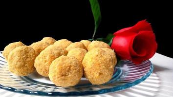 Mouth watering sweet - Besan laddoo made by roasted gram flour, ghee, dry fruits and sugar, served in a plate photo