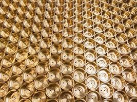 abstract industrial background of shiny brass metal threaded hexagonal parts photo