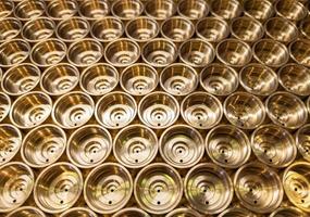 abstract industrial background of shiny brass metal threaded hexagonal parts photo