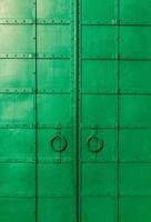 fresh painted old riveted double door photo