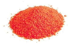 pile of dry red chemical granules - close-up isolated on white background photo