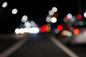 defocused night street view from drivers perspective photo