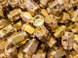 shiny brass parts background, chaotic disorder pile in close-up view with selective focus and dreamy blur photo