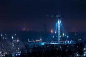 night winter cityscape with light pillars atmospheric phenomenon photo