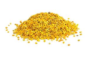 a small heap of bee pollen anules isolated on white background photo