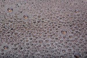 small water drops on the surface of cellphone hydriphobic coated glass screen photo