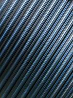 abstract industrial background of many shiny cnc turned rods with flat lay diagonal geometric composition photo