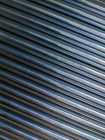 abstract industrial background of shiny cnc turned rods with flat lay diagonal geometric composition photo