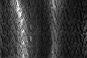 Light glow on grill pattern. Dark industrial abstract background. photo
