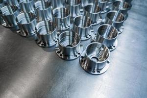 a batch of shiny metal cnc made aerospace parts production - close-up with selective focus for industrial background photo