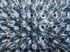 a batch of shiny metal cnc aerospace parts production - close-up flat lay with selective focus for industrial background photo