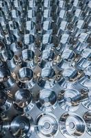 a batch of shiny metal cnc aerospace parts production - close-up in selective focus for industrial full frame background photo