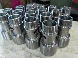 shiny bare steel parts after cnc turning operations close background photo