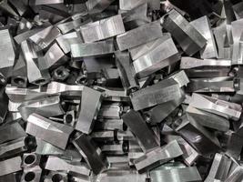 full frame industrial background of pile of shiny steel flat grinded parts