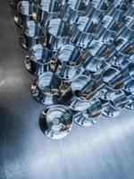 a batch of shiny metal cnc made aerospace parts production - close-up with selective focus for industrial background photo